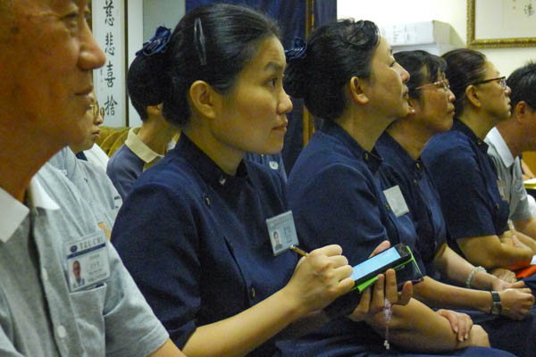 Volunteers listen attentively and take meticulous notes as Liu gives his inspirational talk. Photo by Pua Poo Toong