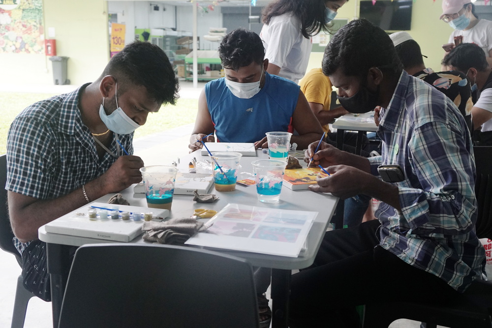 Migrant workers engaging in a painting activity organised by WIMBY. (Photo by Bernard Ng Jia Han)